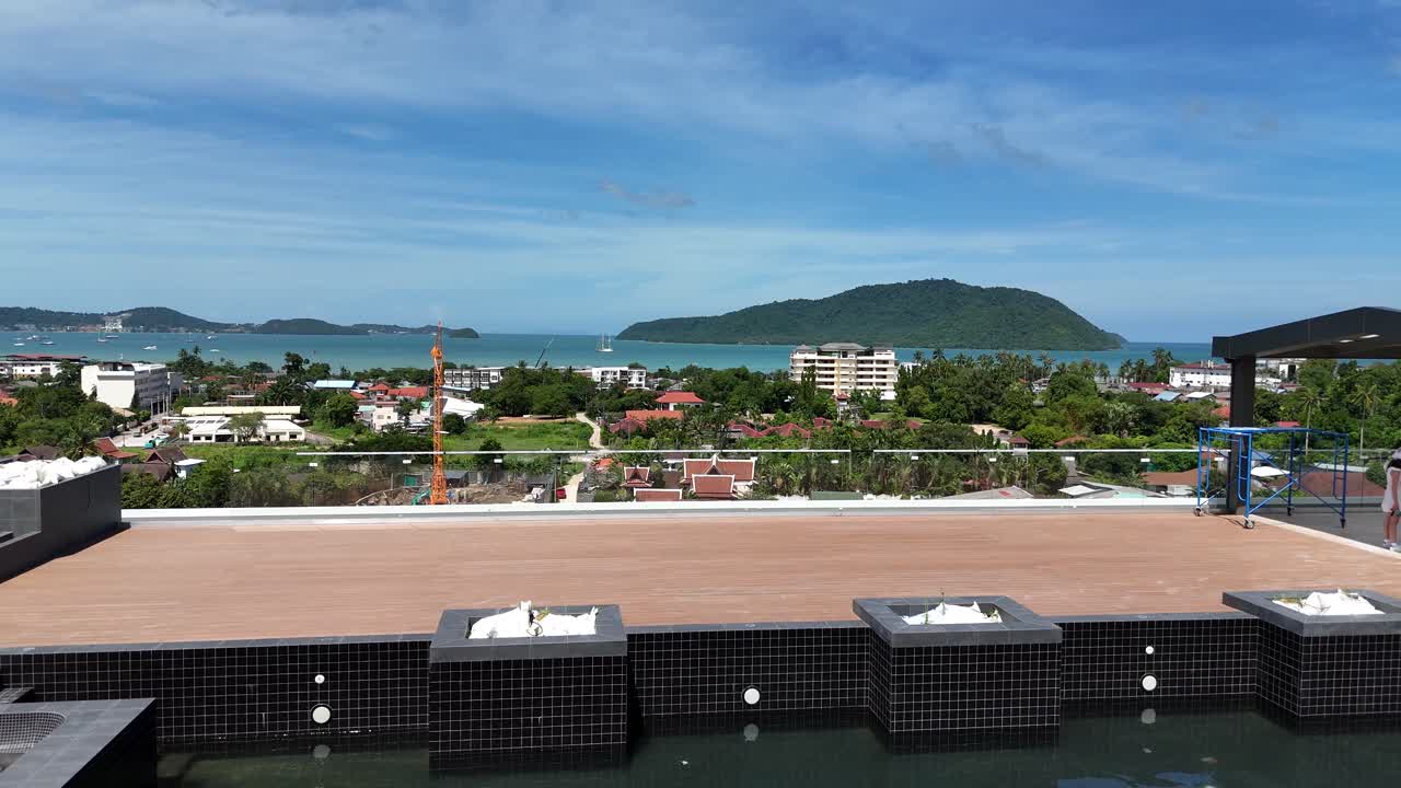 Coastal Town Development with Rooftop Views and Distant Islands