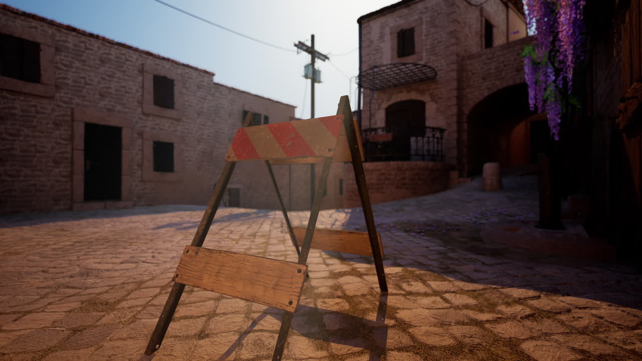 오래된 도시 앞에 바리케이드가 있는 오래된 자갈로 된 거리