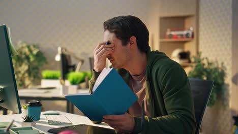 nervous businessman videocalling computer office. stressed man fixing mistakes