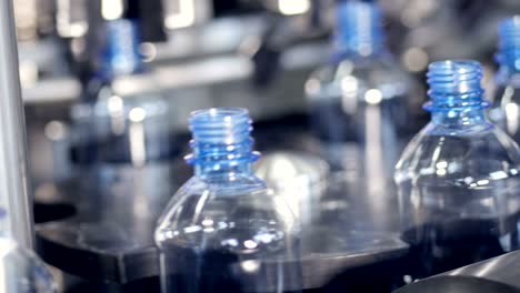 empty pet bottles fed to a star wheel and rotating.