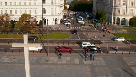 Side-view-of-cars-stopping-and-giving-way-to-pedestrians-on-crosswalk-in-city.-Traffic-in-streets-of-town.-Warsaw,-Poland