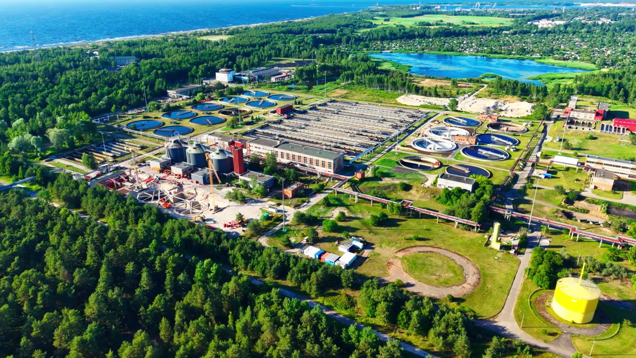 Wide aerial of advanced wastewater infrastructure beside Baltic Sea coastline