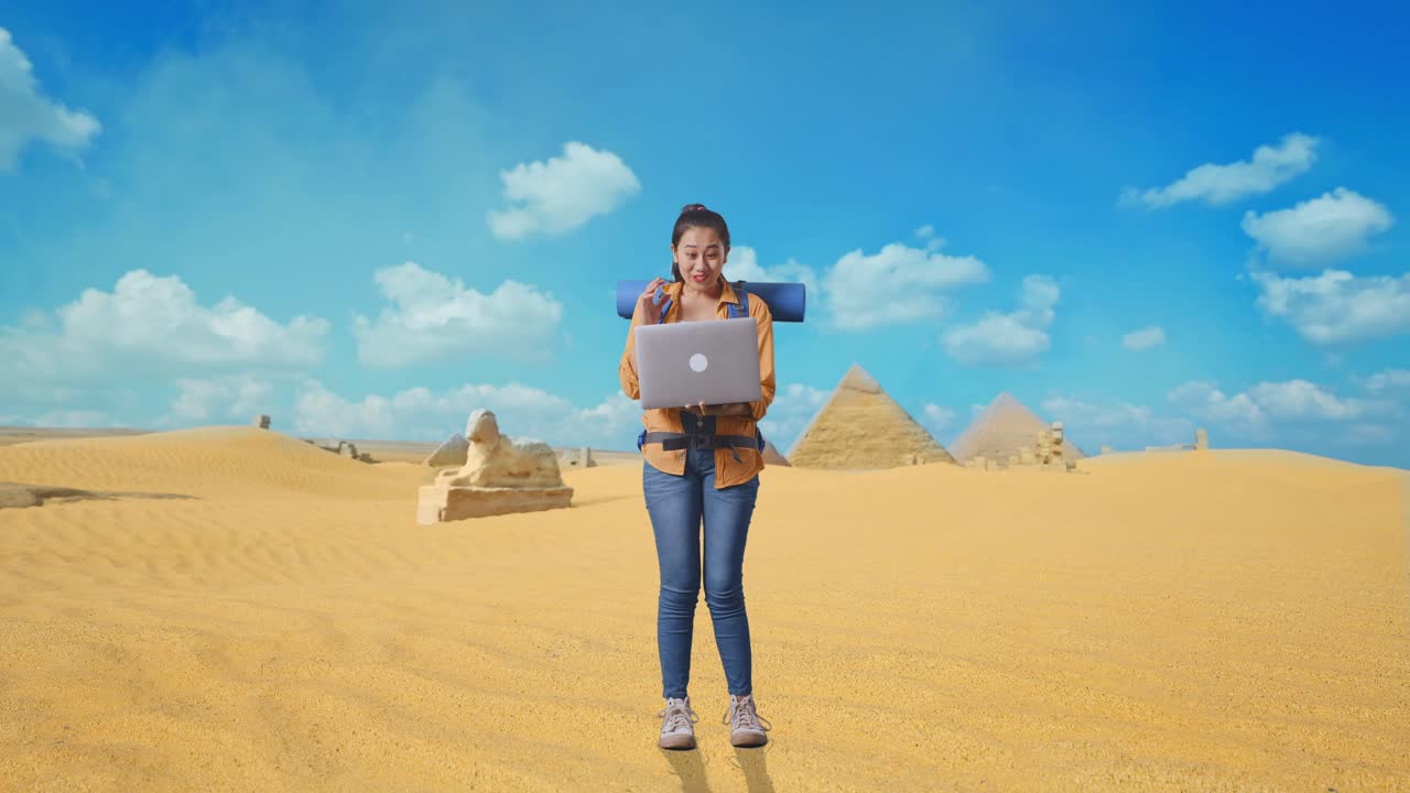 Full Body Of Asian Female Hiker With Mountaineering Backpack Looking At A Laptop And Saying Wow While Traveling In Pyramid Of Giza