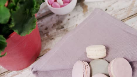 Macaroons-and-pot-plant-with-pink-flowers