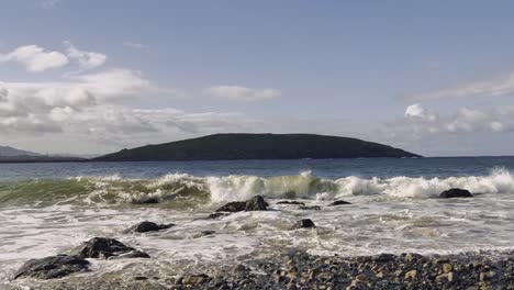 pebble beach wave on blue sky.