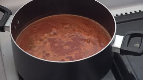 salsa roja boiling on a pot