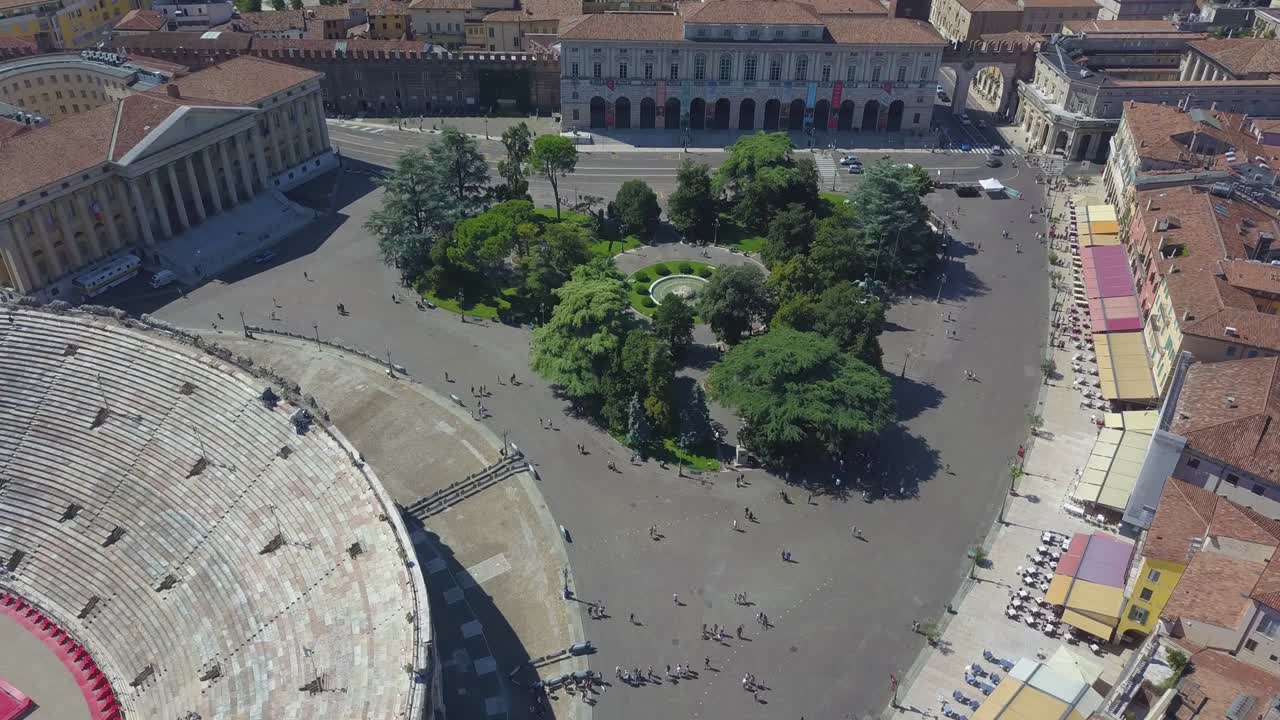Aerial panoramic view of Arena di Verona, Italy. The drone is filming from above Bra Square and people walking. A view of the Arena and the city opens. 4k vieo.