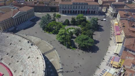 aerial panoramic view of arena di verona, italy. the drone is filming from above bra square and people walking. a view of the arena and the city opens. 4k vieo.