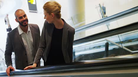 business people interacting on an escalator