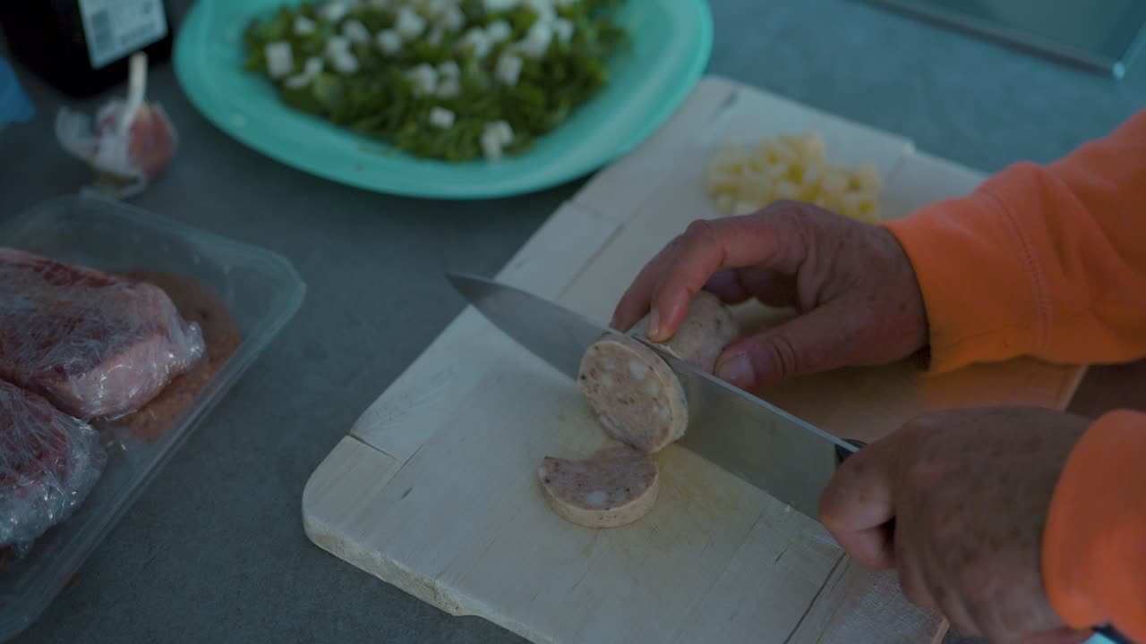 cutting a sausage on a wooden board