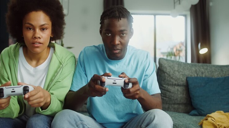 Teenagers playing video games on the couch