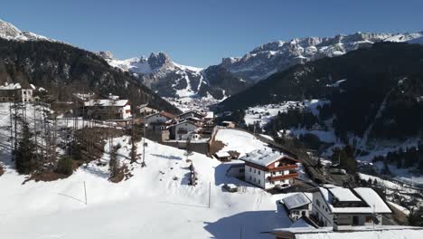 Romantic-village-in-Val-Gardena-valley-on-sunny-winter-day,-Dolomites,-Italy,-aerial-panorama