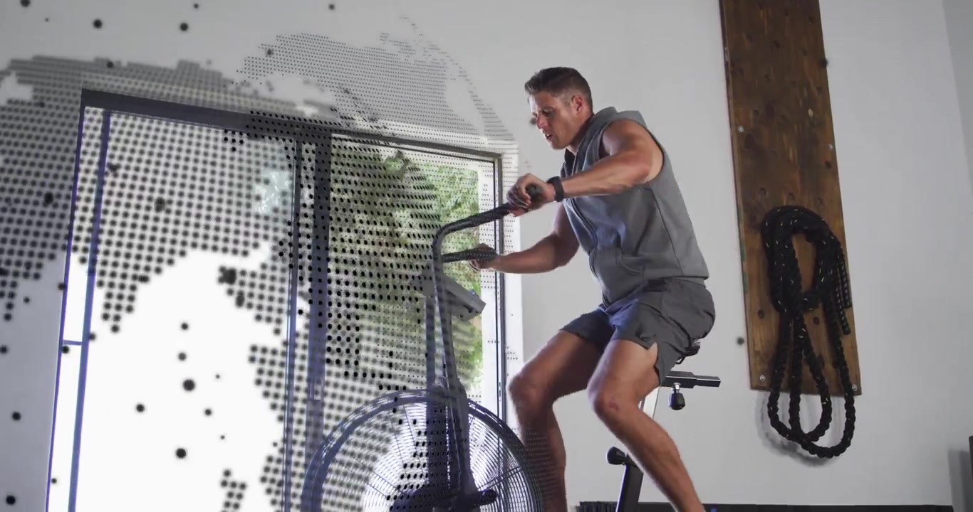 Man pedaling, checking wrist and slowing, dotted globe moving beside him across window for fitness