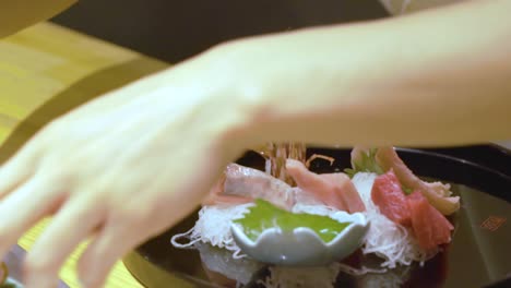 chef arranging fresh chinese food in a black plate in guangzhou, china - close up shot