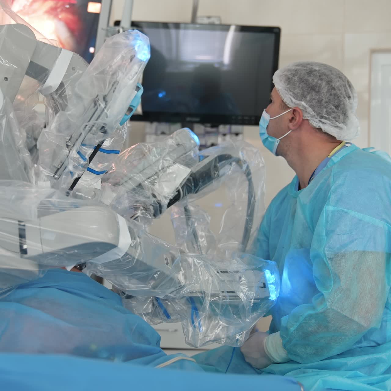 Minimally invasive surgery with robotic equipment. Professional surgeon observes microsurgical process of medical robot on the screen in operating room