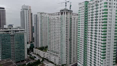 white and high rise buildings in cebu city on a cloudy day - philippines