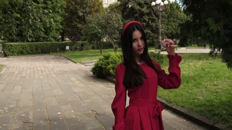 Graceful-brunette-in-red-smiling-in-the-city