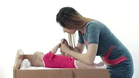 mother cuts nails her baby