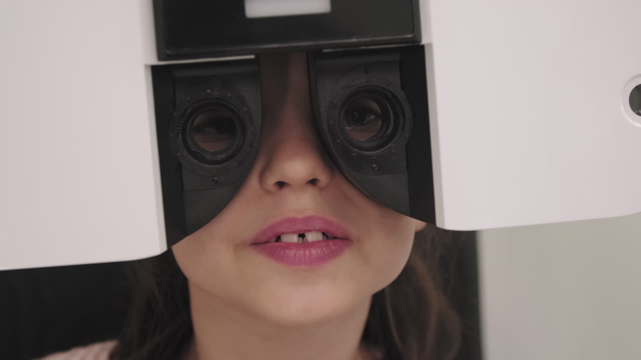 Closeup Of Little Girl Doing Eye Vision Test
