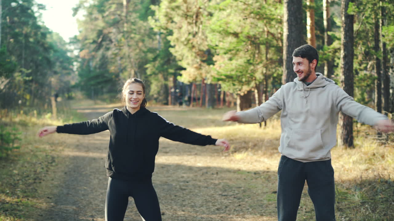 Couple Stretching Outdoors in a Forest