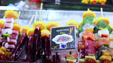 colorful seafood skewers displayed at night market