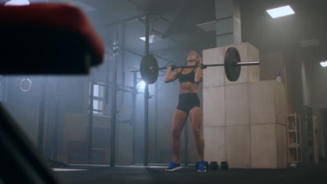 beautiful athletic woman wipes sweat from her forehead with a hand. she's tired after intensive fitness exercise