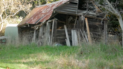 Old-neglected-wooden-shed-with-a-rusty-iron-roof