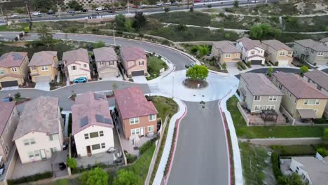 aerial: white vehicle driving through los angeles neighborhood suburb