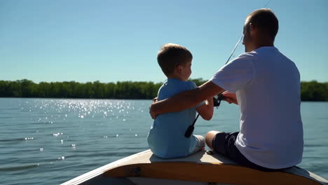 father and son fishing together on a lake