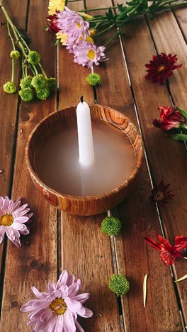 floral candle arrangement on wooden table