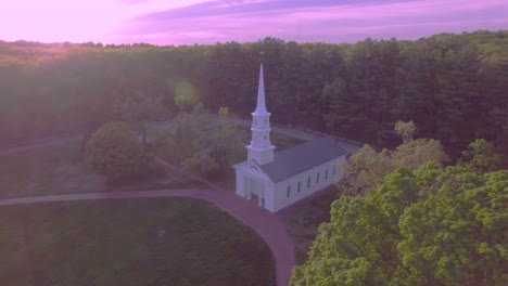 4k circling aerial view of classic new england stone mill and wedding chapel