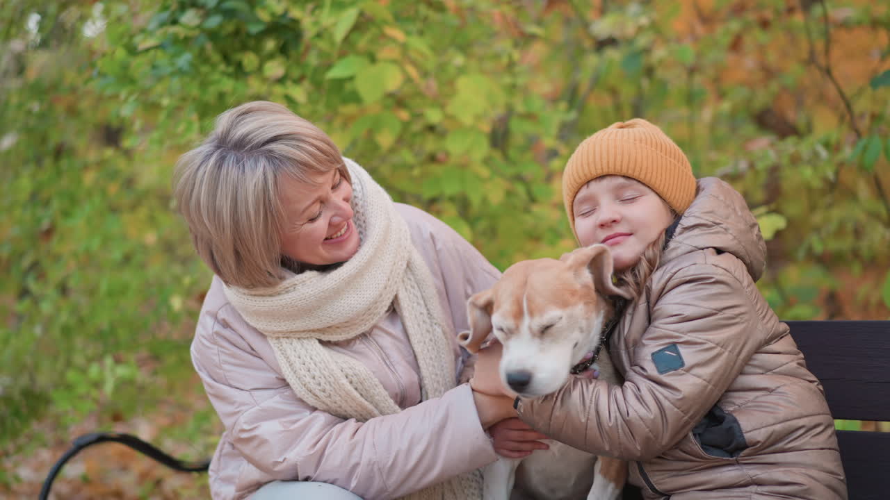 family holding dog warmly on bench amid autumn foliage, parents and child bundled in jackets and scarves, beagle nestled between them, golden leaves, affectionate bond in sunlit woodland