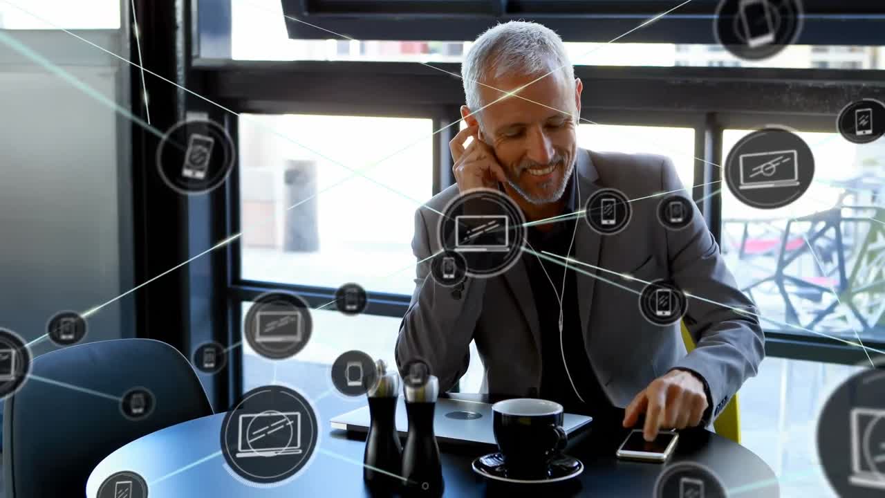 Animation of network of connections with icons over cauacasian businessman using smartphone