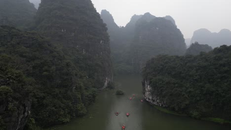 drone shot flying over river and cliffs in the mountainous region of ninh ninh in northern vietnam