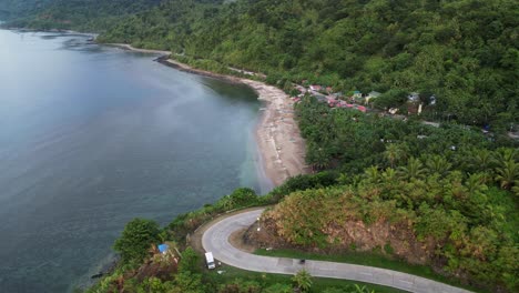 coastal sea ocean water view road to sandy calm beach, philippines aerial