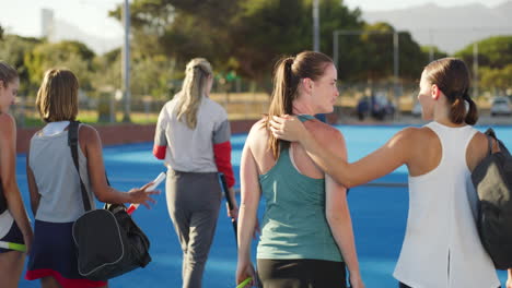 rear view of a group of fit active female hockey