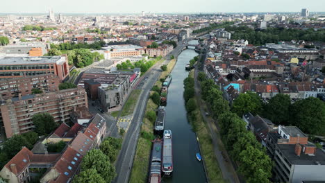 upward reveal of the city of ghent with canal and historical center