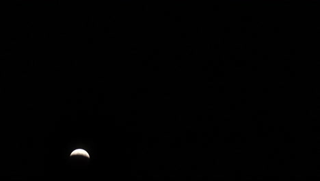 wide timelapse of the total lunar eclipse on march 14th, 2025 as the moon gets covered in earth's shadow