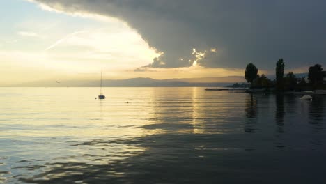 aerial pass by anchored sailboats at sunset