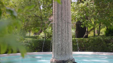 Slow-rotating-shot-of-a-roman-pillar-water-feature-decorating-the-Chateau-de-Castille