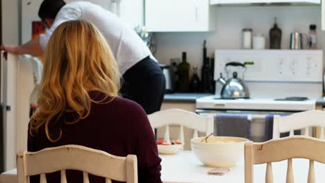 Man-serving-breakfast-to-woman-in-kitchen