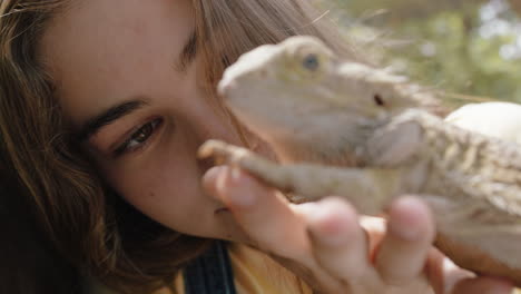 nature girl holding iguana at zoo enjoying excursion to wildlife sanctuary student having fun learning about reptiles 4k