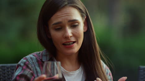 brunette woman chatting on backyard. woman talking with friends on bbq party