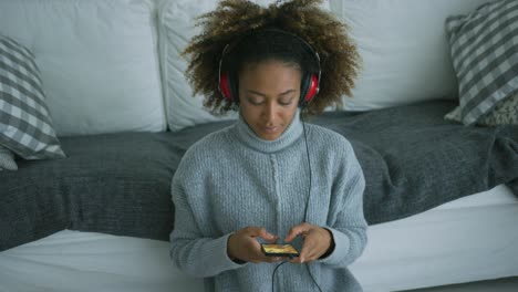 content woman listening to music at home