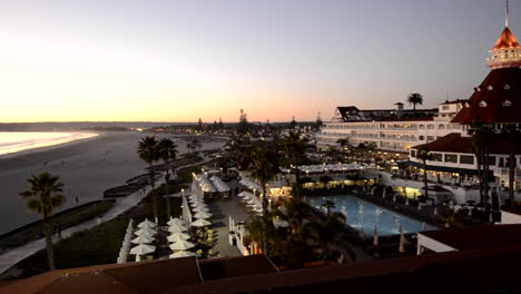 Panning-shot-of-the-beach-and-the-Hotel-Del-Coronado-at-sunset-in-San-Diego-California