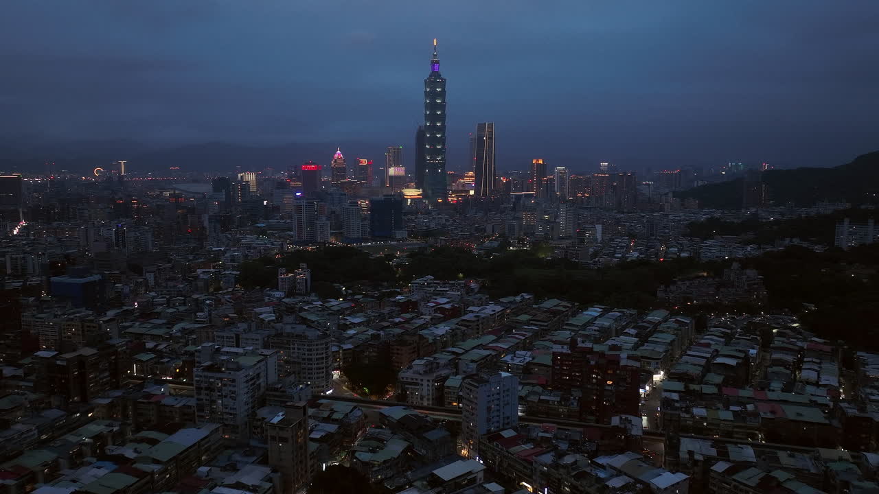 Aerial panorama view of suburb area and downtown of Taipei City with 101 Tower in background during blue hour