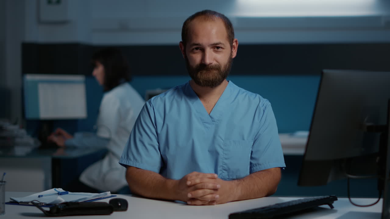 Portrait of a Smiling Male Nurse in Scrubs