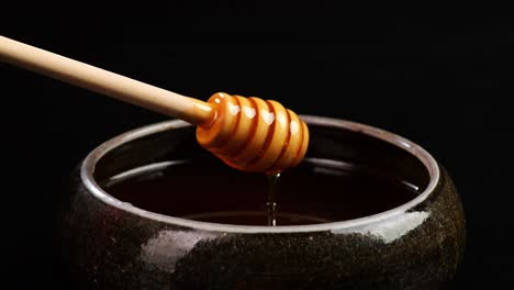 honey dipping from a wooden dipper