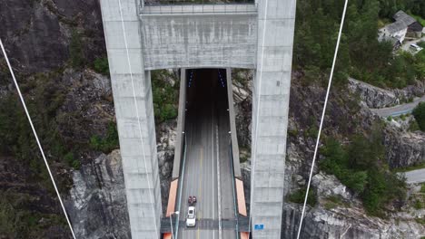 tuuel entrance to massive hardangerbrua suspension bridge - aerial lokking between tower columns into tunnel - norway