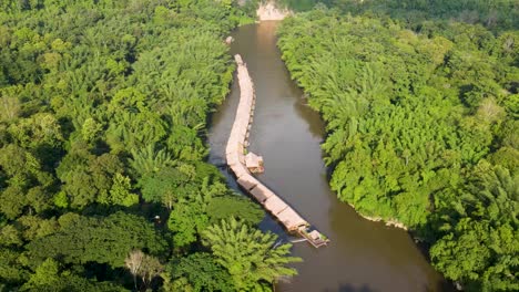 Floating-River-Kwai-hotels-surrounded-by-jungle-in-Kanchanaburi,-at-golden-hour